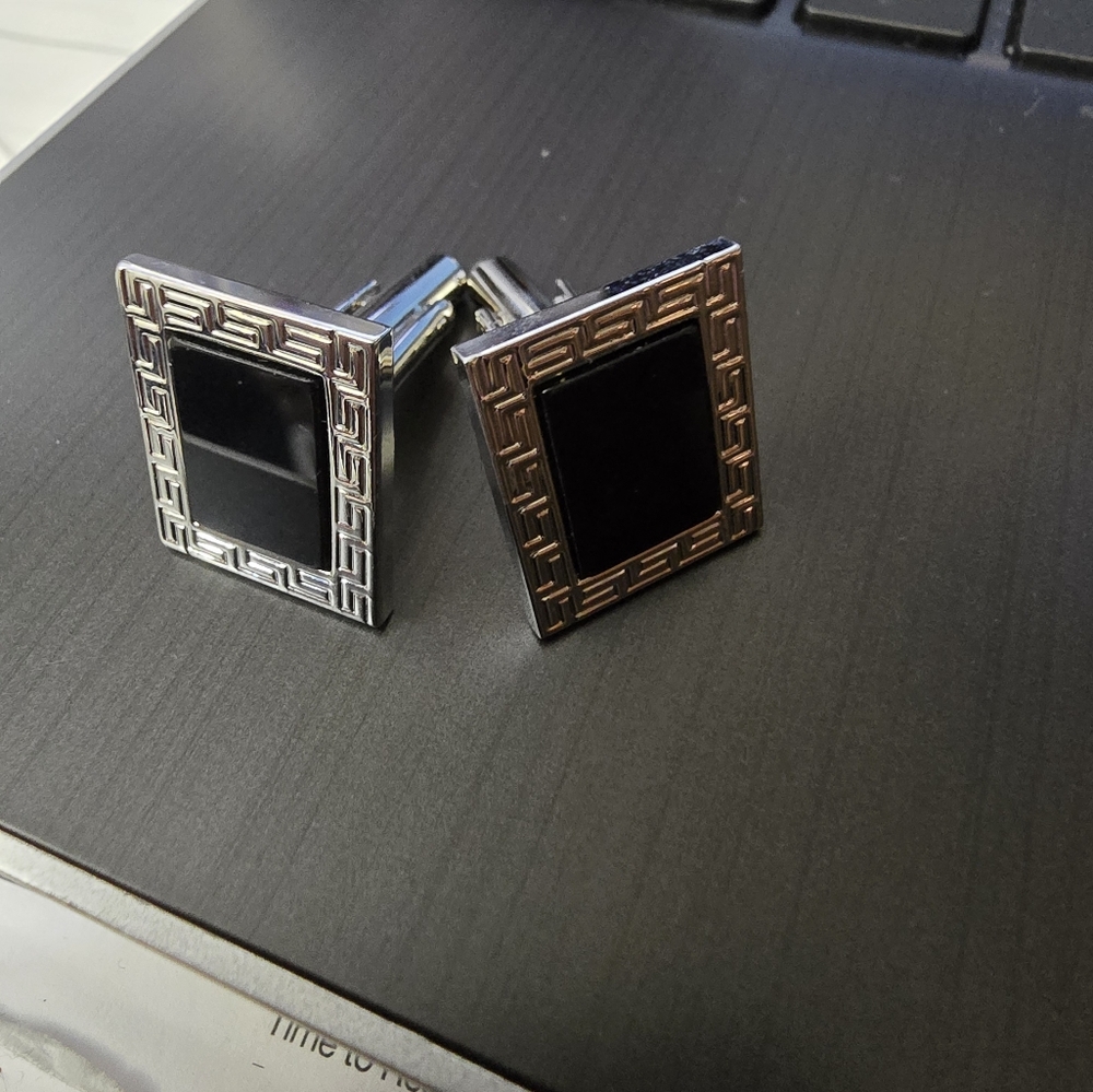 Black and silver colored cufflinks